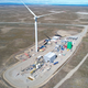 A photo of a synthetic fuel plant in Chile with a large wind turbine.